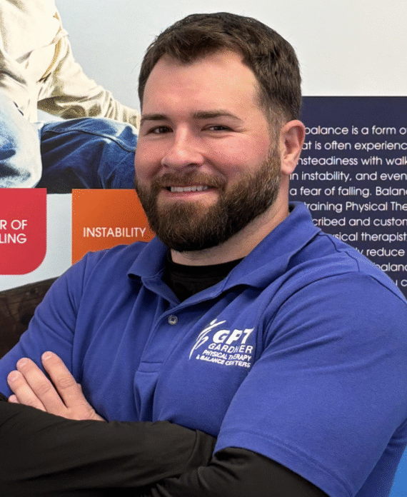 William Diodato, Physical Therapist Assistant at Gardner Physical Therapy, standing in front of a Balance Health display.