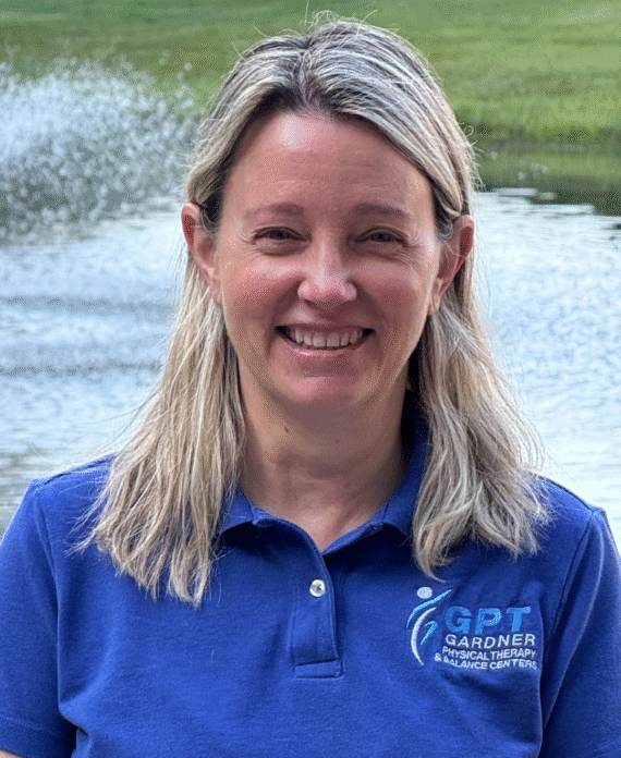 Tina Walas, PTA at Gardner Physical Therapy, smiling in a clinical setting.