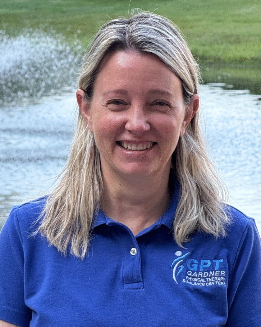 Tina Walas, PTA at Gardner Physical Therapy, smiling in a clinical setting.