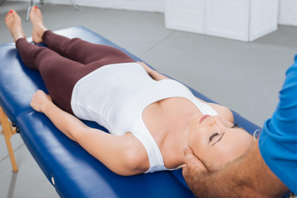 partial view of physiotherapist massaging neck of patient that lying on massage table in clinic - Gardner Physical Therapy partial view of physiotherapist massaging neck of patient that lying on massage table in clinic - Gardner Physical Therapy