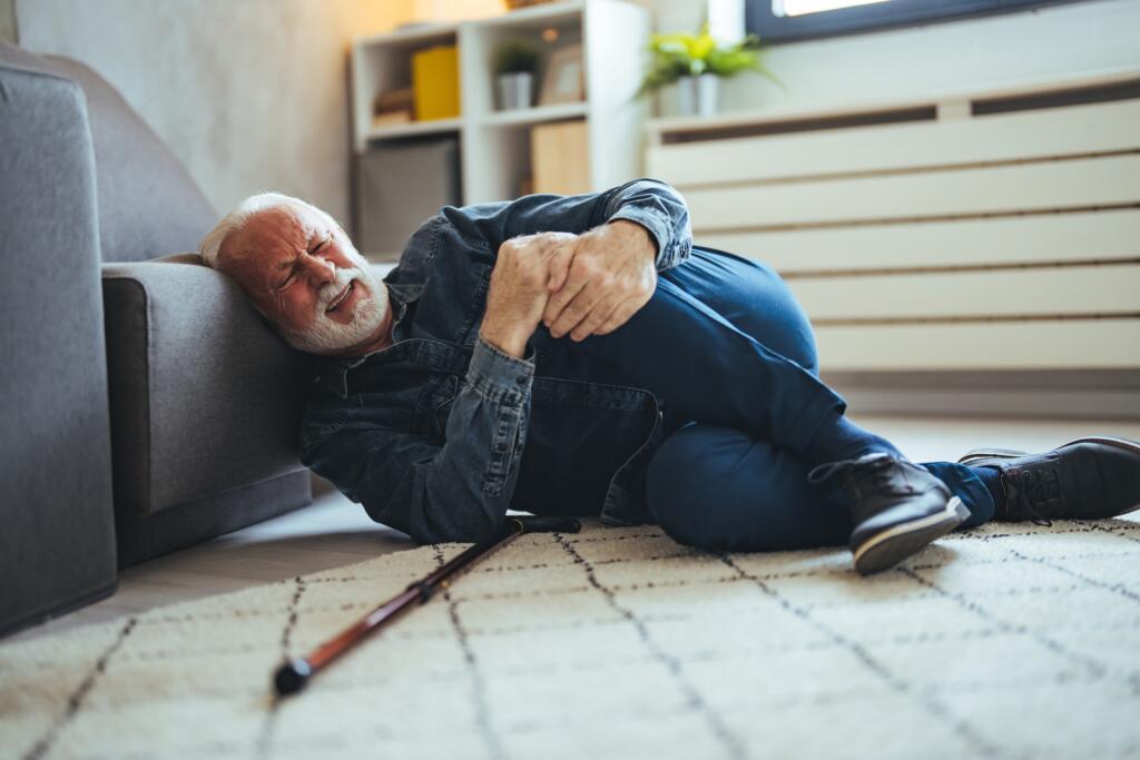 Elderly,Senior,Man,Slip,And,Fall.,Fallen,Old,Person,In - Gardner Physical Therapy Senior man on the floor after a fall at home, highlighting the importance of fall prevention therapy at Gardner Physical Therapy.