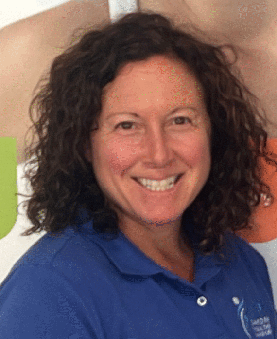 Monica Edelmann, MS, PT, experienced physical therapist at Gardner Physical Therapy, smiling in a clinical setting.