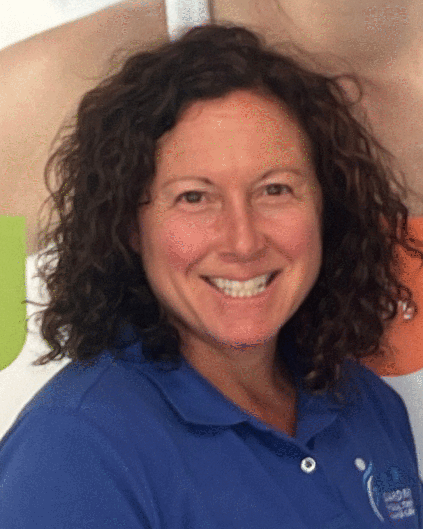 Monica Edelmann, MS, PT, experienced physical therapist at Gardner Physical Therapy, smiling in a clinical setting.