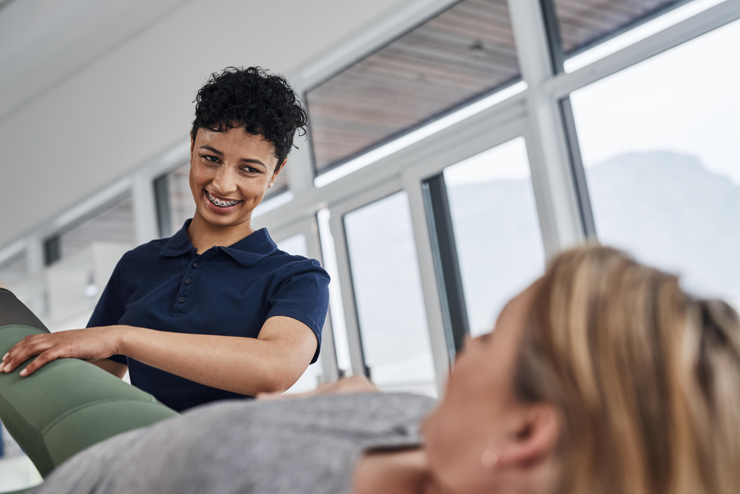 herapist assisting patient with leg stretches at Physical Therapy West Ocean City.
